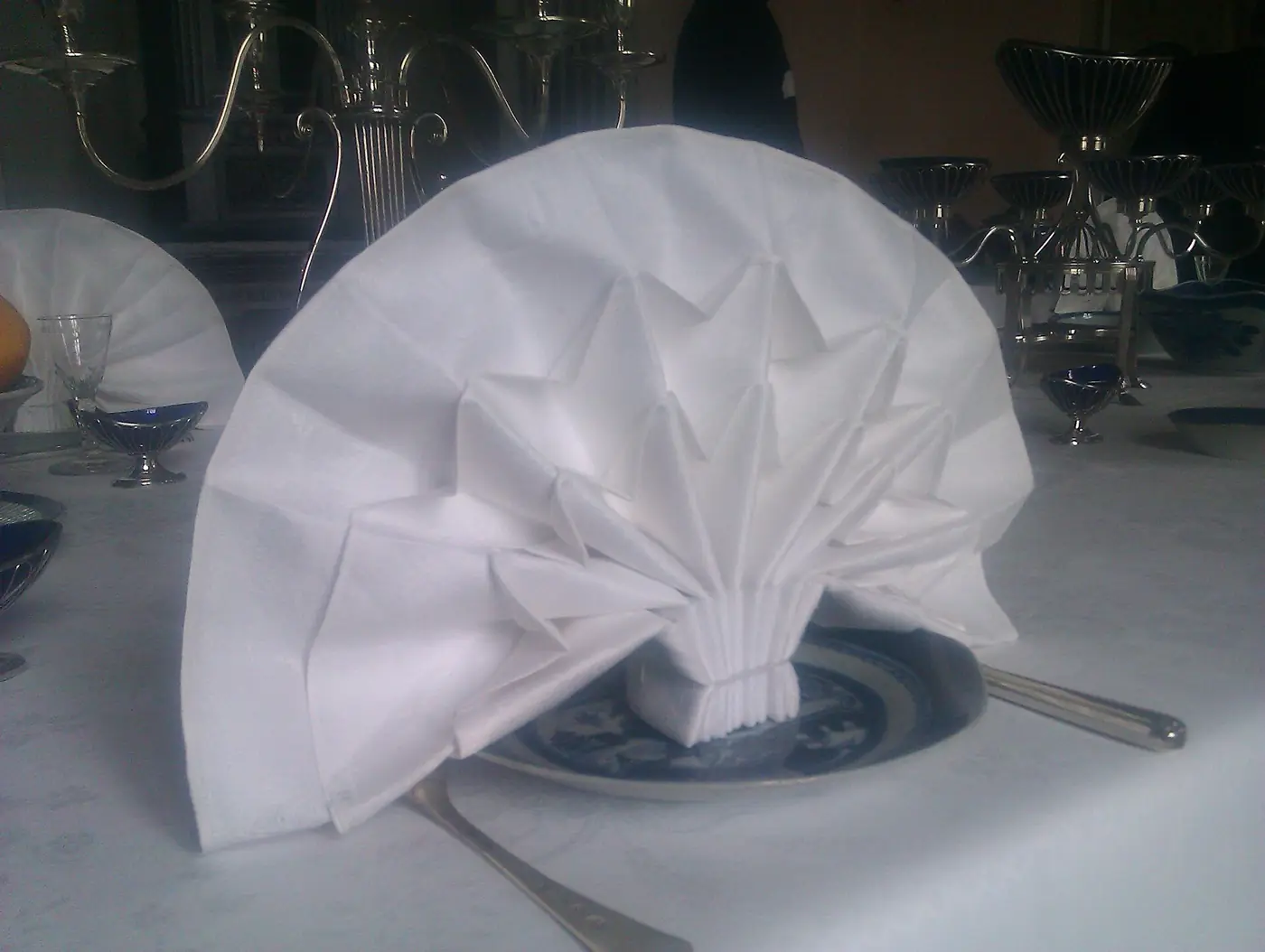 A folded linen napkin on a laid table